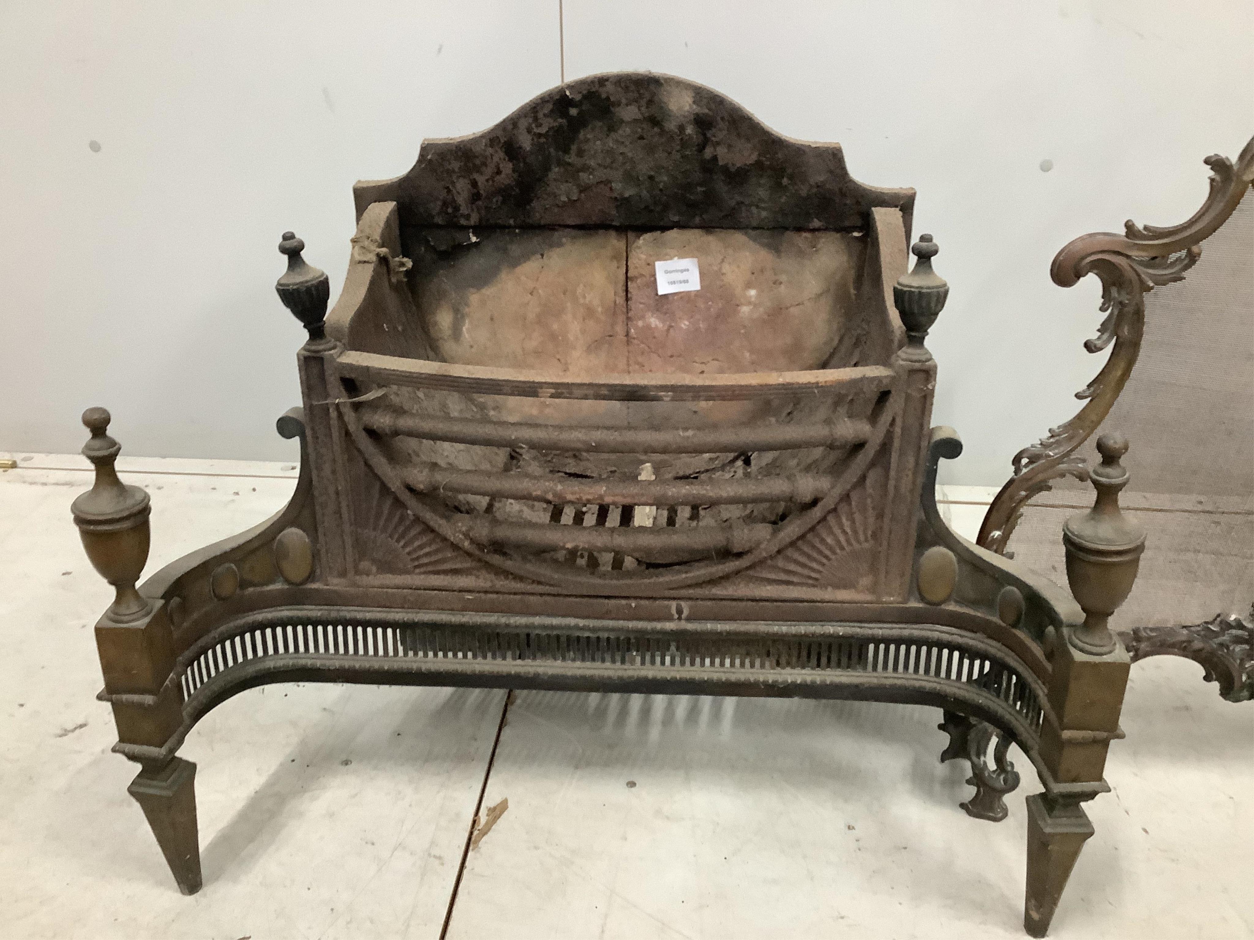 An Adam design brass mounted cast iron fire grate, width 74cm, depth 44cm, height 65cm, together with a brass rococo style mesh firescreen. Condition - poor to fair